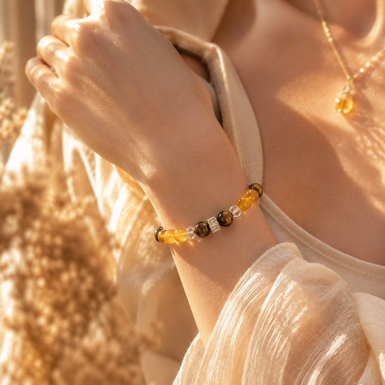 Citrine and tiger eye bracelet worn on the wrist in sunlight