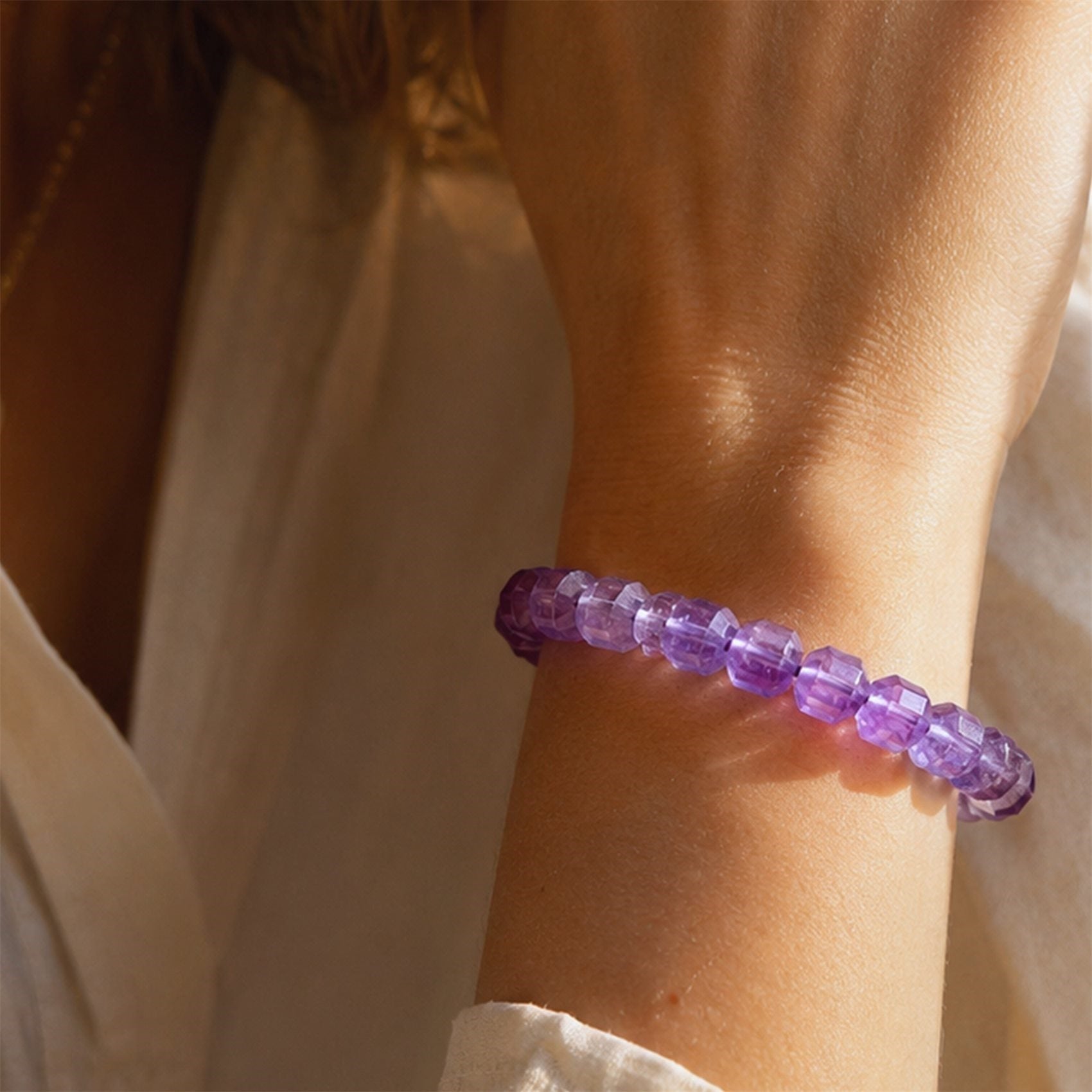Amethyst bracelet worn on wrist